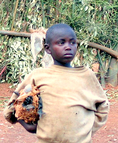 A child in Benin holds a soccer ball fashioned from paper.