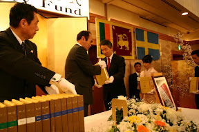 Japanese  Dhamma Society Patrons hand-carry Roman-script Tipitaka to be placed on high table, Osaka, 2007. 