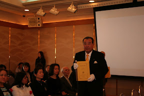 One of the leaders of business community carring Tipitaka in Roman-script into the ceremony hall, Osaka, 2007. 