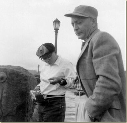 John (perusing Polaroid photo) and Charles Flora at Niagara Falls around 1956. 
