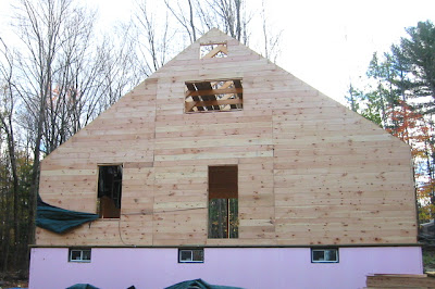 Sheathing the North wall is done too, except that very top window