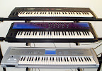 My former 3-tier keyboard stand... Top to bottom: Yamaha SY-35, Ensoniq FIZMO, Korg Triton Workstation