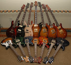 My PRS collection as of Aug 2006... L to R back: McCarty Standard (metallic red), McCarty Soapbar (black w/ natural binding), McCarty Rosewood (natural), Hollowbody II (violin amber burst), Singlecut (black sunburst), Custom 22 semi-hollow (tobacco sunburst), Custom 22/12 (dark cherry sunburst); L to R front: EG-1 (tri-color sunburst), Swamp Ash Special (emerald green), Custom 24 (whale blue), Custom 24 (violin amber burst), Custom 24 (cherry sunburst), Custom 24 (gray black), Standard 24 (royal blue)
