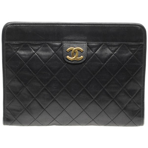 Vintage leather clutch bag by Chanel Quilted design with gold tone logo